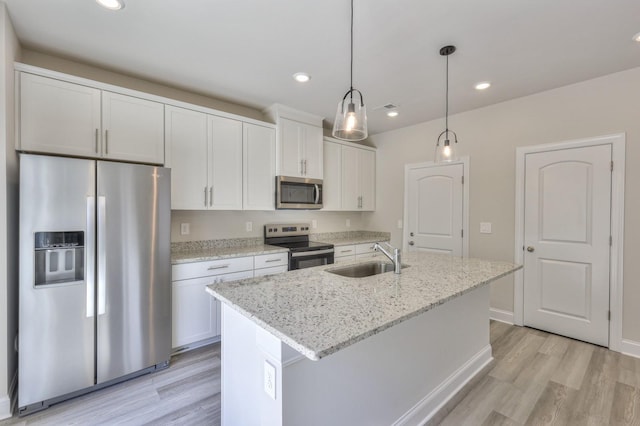 1753 Flora Grv, Hermitage, TN 37076 - kitchen featuring appliances with stainless steel finishes, light wood finished floors, white cabinets, a kitchen island with sink, and recessed lighting