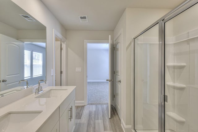 1753 Flora Grv, Hermitage, TN 37076 - bathroom with wood finished floors, double vanity, and a stall shower