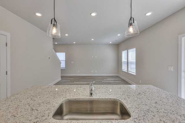 1753 Flora Grv, Hermitage, TN 37076 - kitchen with light stone counters, recessed lighting, hanging light fixtures, open floor plan, and wood finished floors