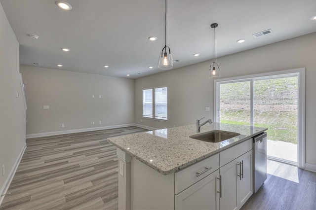 1753 Flora Grv, Hermitage, TN 37076 - kitchen featuring stainless steel dishwasher, light wood-type flooring, recessed lighting, white cabinetry, and a kitchen island with sink