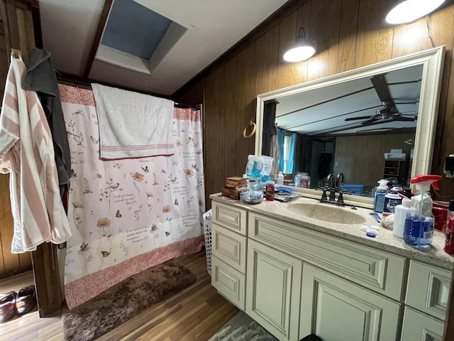 3406 Lowes Gap Rd, Pikeville, TN 37367 - full bath featuring wood walls, wood finished floors, vanity, curtained shower, and a ceiling fan