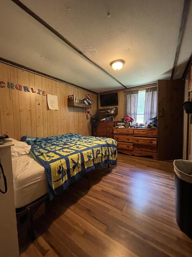 3406 Lowes Gap Rd, Pikeville, TN 37367 - bedroom with wood finished floors, wooden walls, and a textured ceiling
