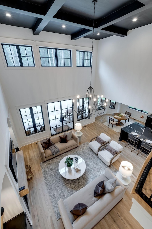 1050 Garton Rd, Burns, TN 37029 - living area featuring coffered ceiling, beam ceiling, wood finished floors, and a chandelier