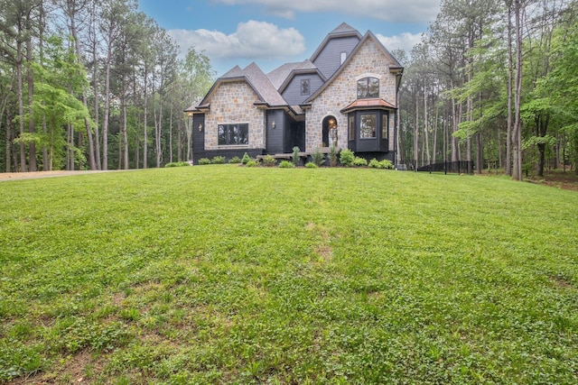 1050 Garton Rd, Burns, TN 37029 - french country style house featuring stone siding and a front lawn