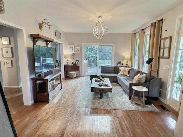 4417 Jackson Hollow Rd, Franklin, TN 37064 - living room featuring wood finished floors, plenty of natural light, and a chandelier