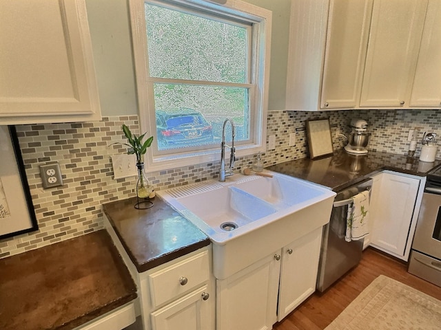 4417 Jackson Hollow Rd, Franklin, TN 37064 - kitchen with white cabinetry, stainless steel appliances, decorative backsplash, and dark countertops