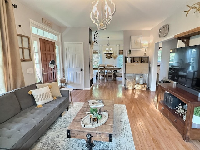 4417 Jackson Hollow Rd, Franklin, TN 37064 - living room with a chandelier, light wood-type flooring, and healthy amount of natural light