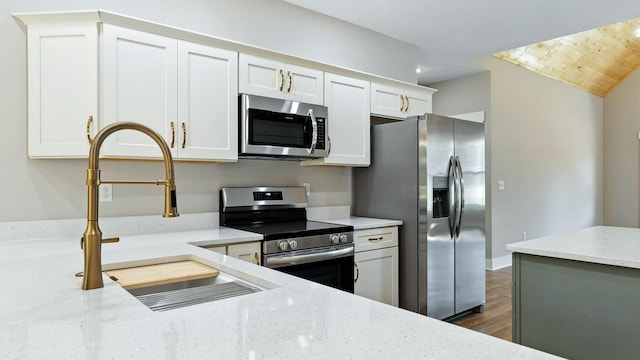 570 Main St S, Ashland City, TN 37015 - kitchen featuring stainless steel appliances, white cabinets, light stone countertops, dark wood finished floors, and recessed lighting
