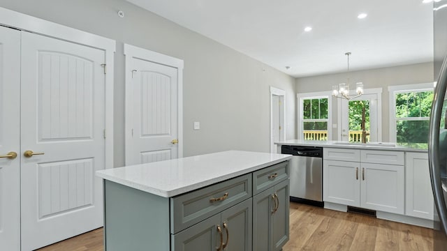 570 Main St S, Ashland City, TN 37015 - kitchen with stainless steel dishwasher, gray cabinets, light wood-type flooring, a kitchen island, and a chandelier