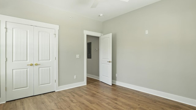 570 Main St S, Ashland City, TN 37015 - unfurnished bedroom featuring electric panel, wood finished floors, a closet, and ceiling fan