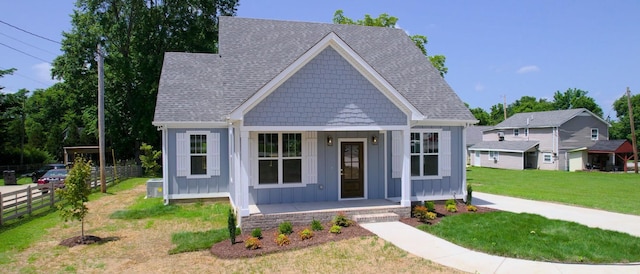 570 Main St S, Ashland City, TN 37015 - view of front of house with board and batten siding, roof with shingles, and covered porch