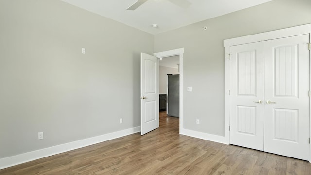 570 Main St S, Ashland City, TN 37015 - unfurnished bedroom featuring wood finished floors, a closet, ceiling fan, and freestanding refrigerator
