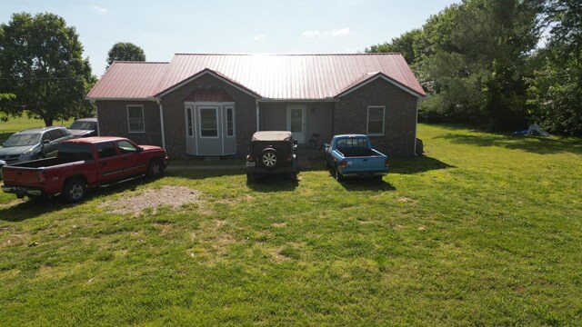 4009 Sawmill Rd, Woodlawn, TN 37191 - view of front of home with a metal roof and a front lawn