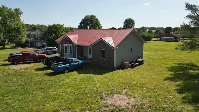 4009 Sawmill Rd, Woodlawn, TN 37191 - view of property exterior with a metal roof and a yard