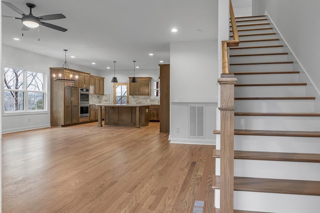 418 Stonemeadow Rd, Clarksville, TN 37043 - stairs featuring ceiling fan, wood finished floors, and recessed lighting