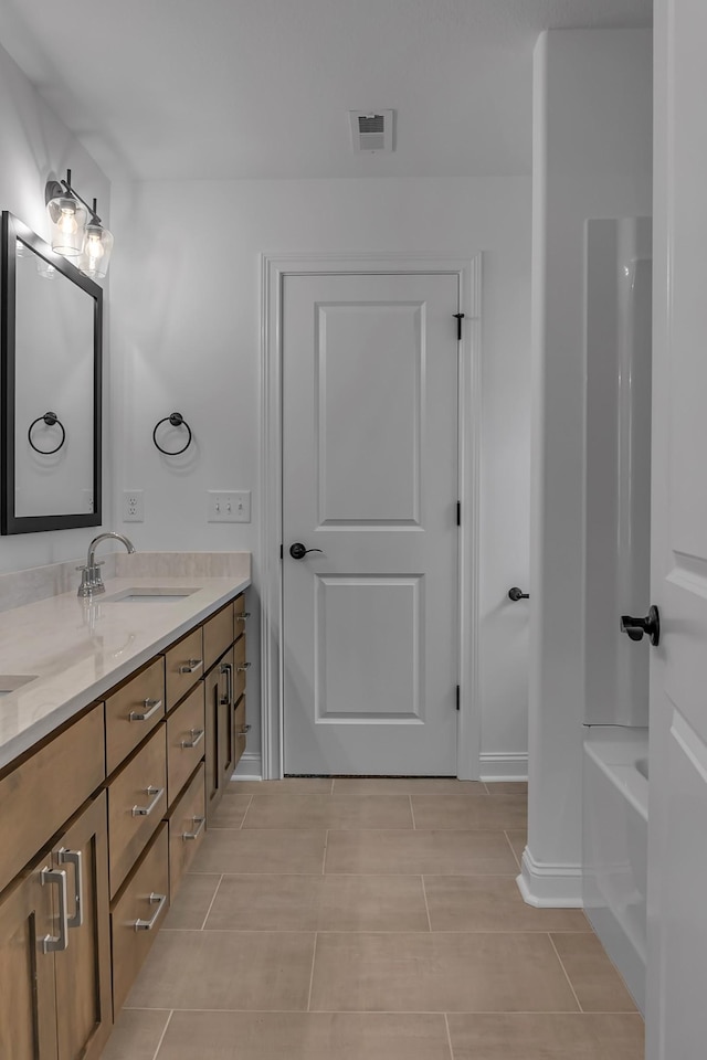418 Stonemeadow Rd, Clarksville, TN 37043 - full bath featuring double vanity, tile patterned floors, and shower / washtub combination