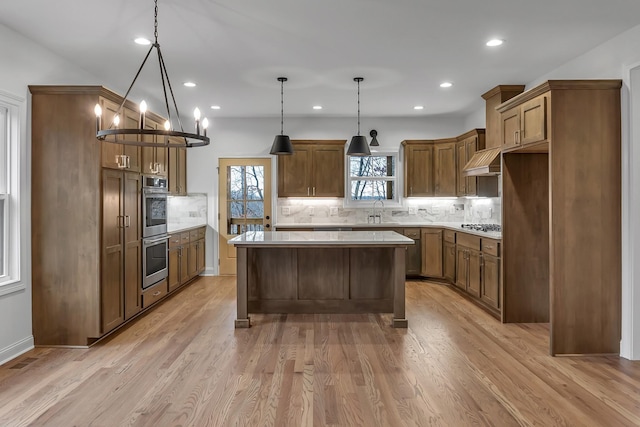 418 Stonemeadow Rd, Clarksville, TN 37043 - kitchen with double oven, backsplash, custom exhaust hood, a center island, and light countertops