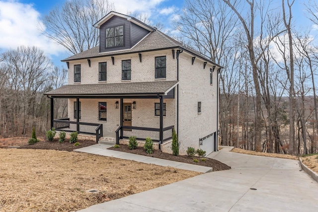 418 Stonemeadow Rd, Clarksville, TN 37043 - view of front of house featuring covered porch, brick siding, concrete driveway, roof with shingles, and a garage