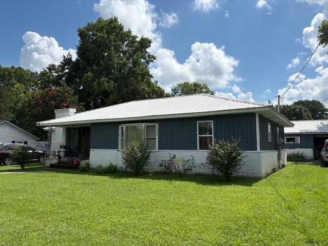 102 Thorogood St, Cowan, TN 37318 - view of front facade with a front yard and board and batten siding