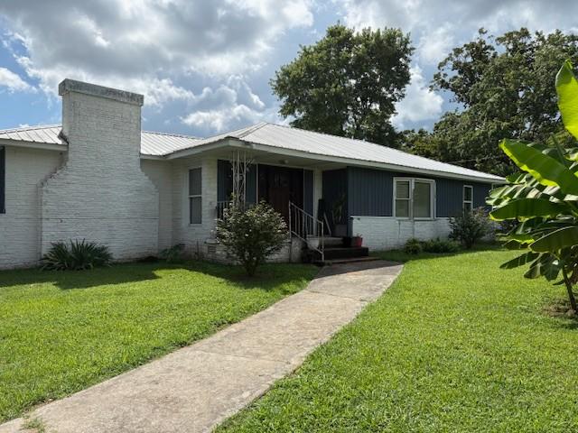 102 Thorogood St, Cowan, TN 37318 - view of front facade with a front yard and a metal roof