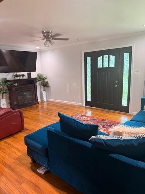 102 Thorogood St, Cowan, TN 37318 - living room with wood finished floors, ornamental molding, ceiling fan, and a glass covered fireplace