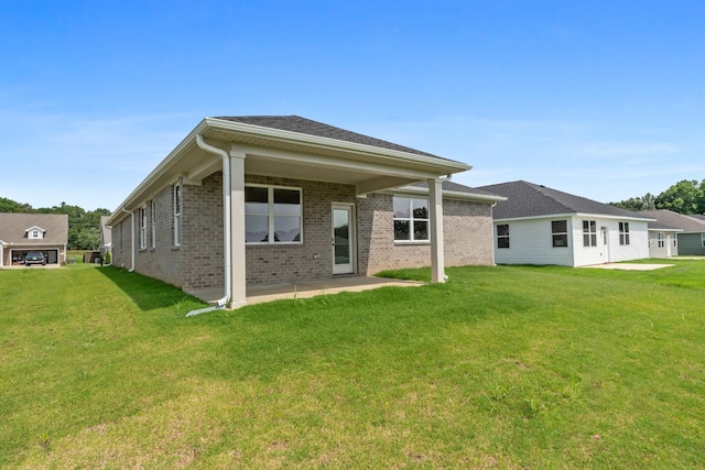 15 Aurora Cir, Fayetteville, TN 37334 - rear view of house with a lawn, brick siding, and a patio area