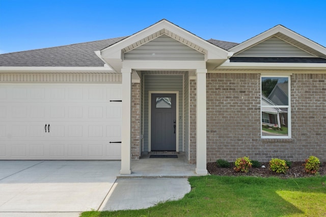 15 Aurora Cir, Fayetteville, TN 37334 - view of exterior entry with a shingled roof, a garage, brick siding, and concrete driveway