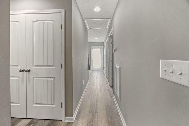 332 Riddle Ln, Estill Springs, TN 37330 - corridor featuring wood finished floors and attic access