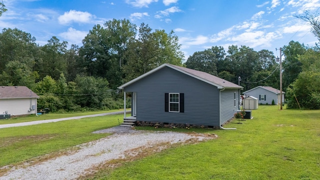 332 Riddle Ln, Estill Springs, TN 37330 - view of home's exterior with a storage unit, a yard, and driveway