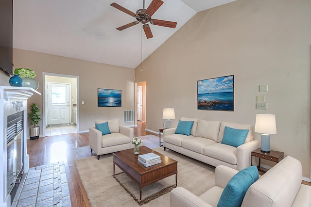 302 Laurel Hill Dr, Old Hickory, TN 37138 - living room featuring a ceiling fan, high vaulted ceiling, light wood-style floors, and a tiled fireplace