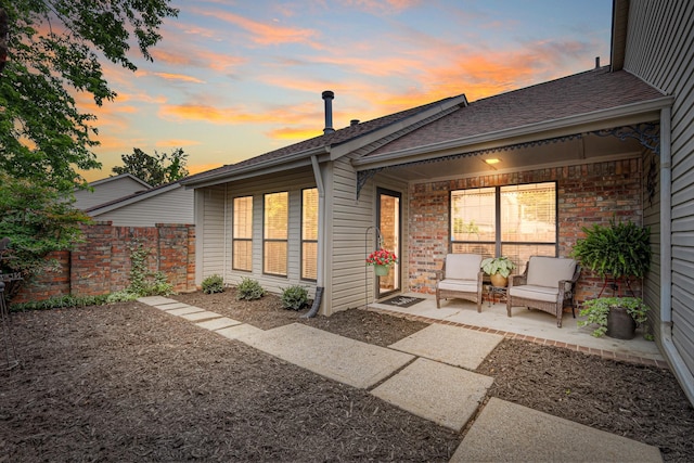 302 Laurel Hill Dr, Old Hickory, TN 37138 - back of property at dusk featuring roof with shingles and brick siding