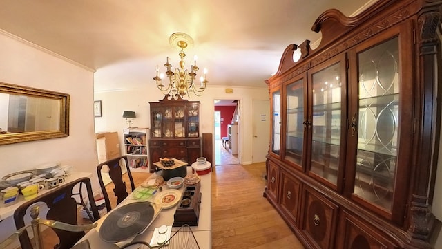 204 Fisher Ave, Carthage, TN 37030 - dining area with light wood-style flooring, a chandelier, and crown molding