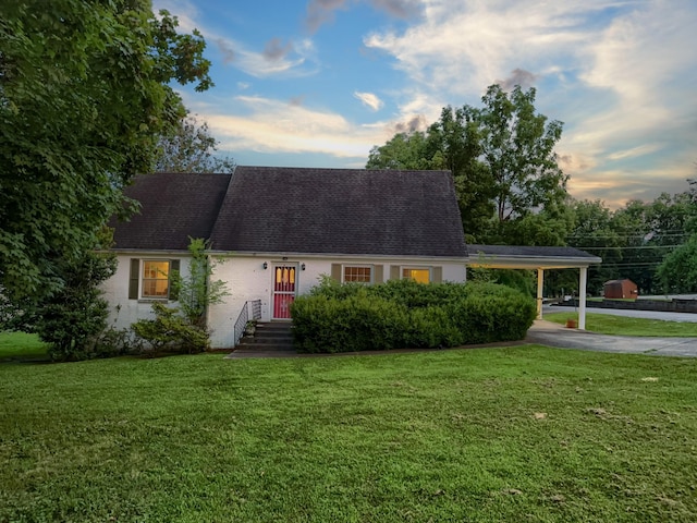 204 Fisher Ave, Carthage, TN 37030 - cape cod-style house with driveway, an attached carport, a front lawn, and roof with shingles
