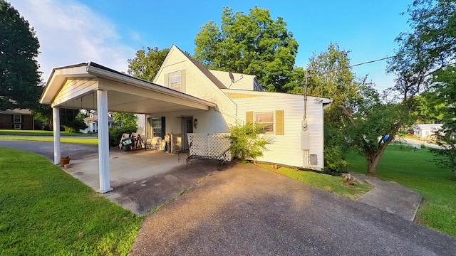 204 Fisher Ave, Carthage, TN 37030 - exterior space featuring an attached carport, driveway, a lawn, and a patio