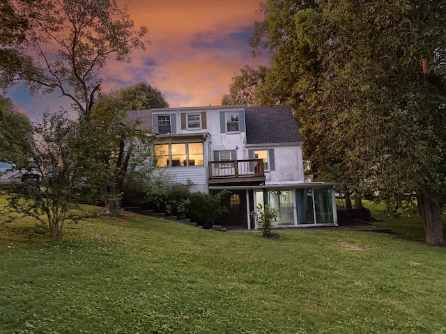 204 Fisher Ave, Carthage, TN 37030 - rear view of house featuring a sunroom, a yard, roof with shingles, and a balcony