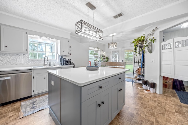 3506 New Windsor Ct, Antioch, TN 37013 - kitchen with stainless steel dishwasher, light countertops, a center island, tasteful backsplash, and hanging light fixtures