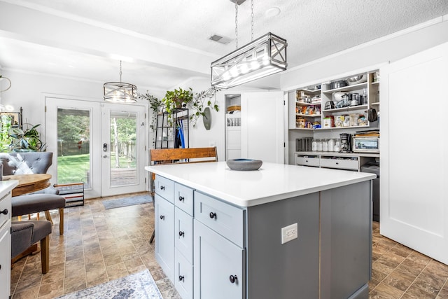 3506 New Windsor Ct, Antioch, TN 37013 - kitchen with a center island, light countertops, open shelves, hanging light fixtures, and a chandelier