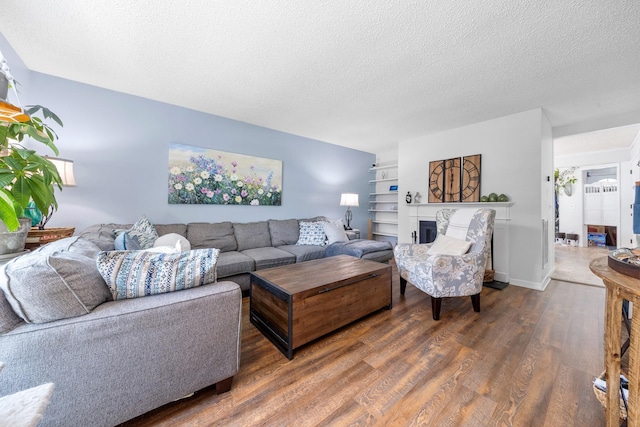 3506 New Windsor Ct, Antioch, TN 37013 - living area featuring wood finished floors, a textured ceiling, and a fireplace