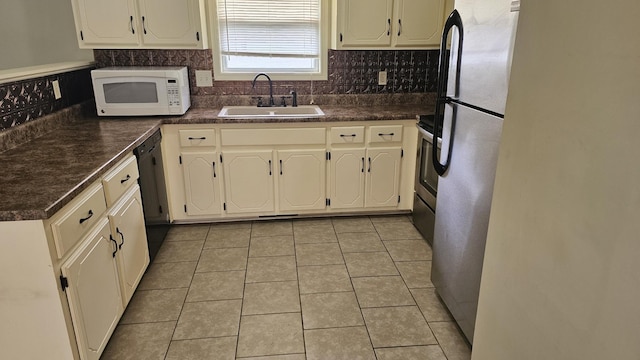 1949 Timberline Cir, Oak Grove, KY 42262 - kitchen with appliances with stainless steel finishes, dark countertops, light tile patterned floors, and tasteful backsplash