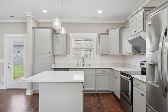 1412 Wrangler Ln, Smyrna, TN 37167 - kitchen with appliances with stainless steel finishes, dark wood-style floors, ornamental molding, light countertops, and tasteful backsplash
