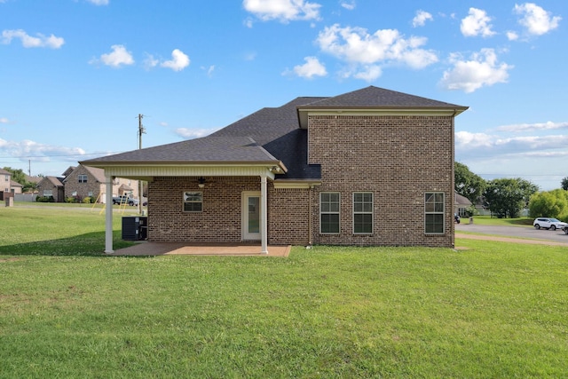 1412 Wrangler Ln, Smyrna, TN 37167 - rear view of house featuring a lawn, brick siding, a patio area, and roof with shingles