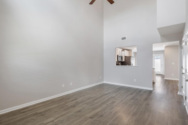 215 Ruth Way, Spring Hill, TN 37174 - unfurnished living room with a ceiling fan, dark wood-type flooring, and a towering ceiling