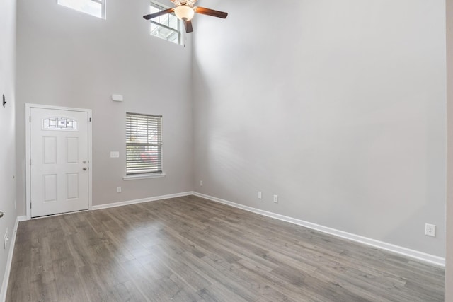 215 Ruth Way, Spring Hill, TN 37174 - unfurnished living room featuring a towering ceiling, a ceiling fan, and wood finished floors