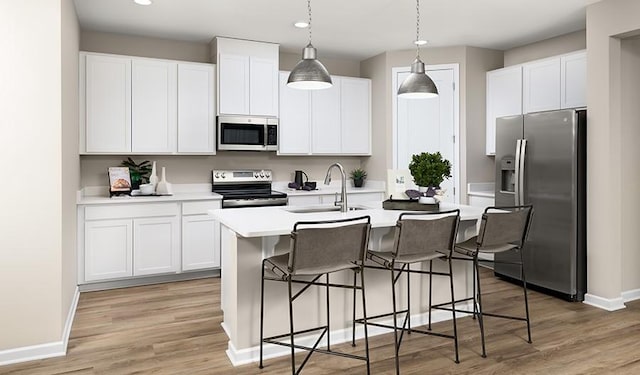 1768 Williamsport Lndg, Columbia, TN 38401 - kitchen with stainless steel appliances, a kitchen island with sink, light countertops, white cabinets, and recessed lighting