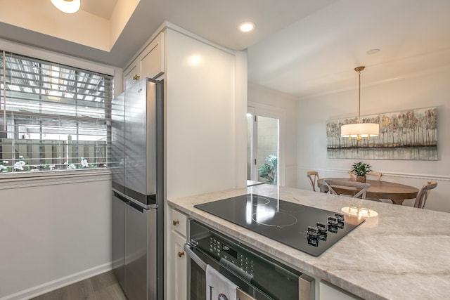 1002 E Northfield Blvd Unit A102, Murfreesboro, TN 37130 - kitchen with black appliances, light countertops, dark wood-style floors, decorative light fixtures, and white cabinetry