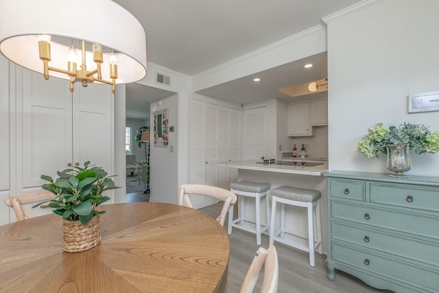 1002 E Northfield Blvd Unit A102, Murfreesboro, TN 37130 - dining area featuring a chandelier, light wood finished floors, ornamental molding, and recessed lighting