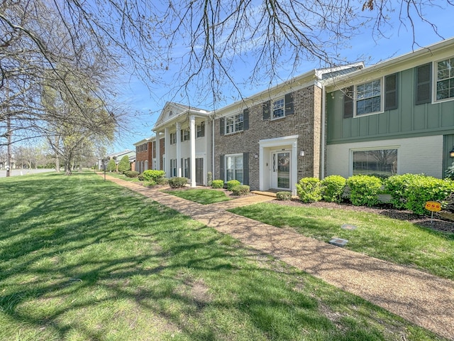 1002 E Northfield Blvd Unit A102, Murfreesboro, TN 37130 - view of front of house with brick siding, a front lawn, and board and batten siding