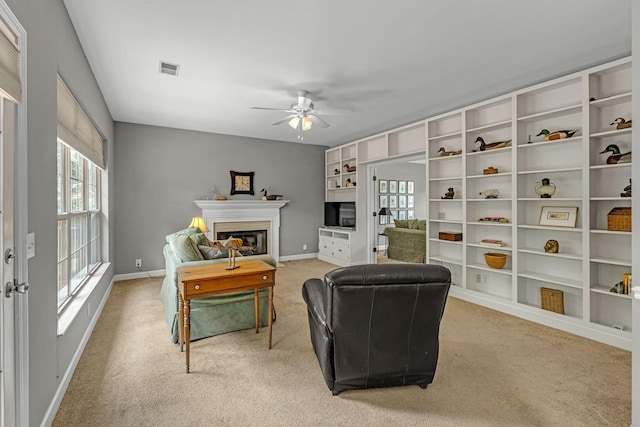 205 Seneca Ct, Franklin, TN 37067 - living area featuring light colored carpet, ceiling fan, and a glass covered fireplace