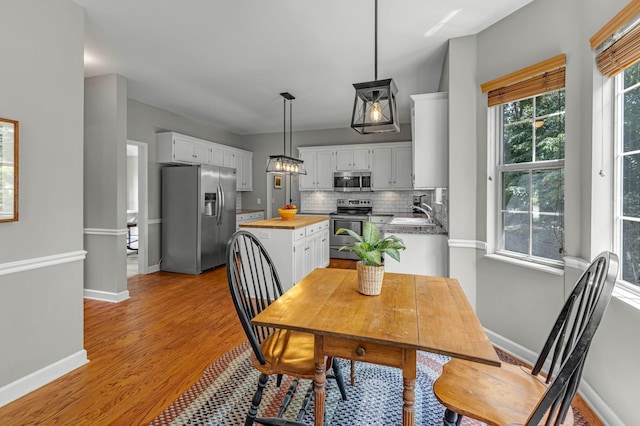205 Seneca Ct, Franklin, TN 37067 - dining room featuring baseboards and light wood-style flooring