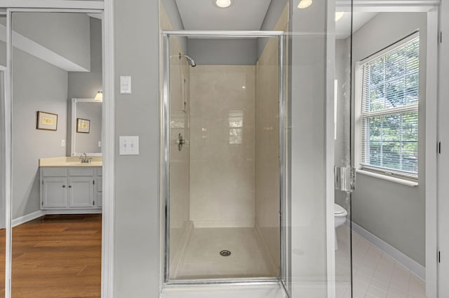 205 Seneca Ct, Franklin, TN 37067 - bathroom with vanity, a stall shower, healthy amount of natural light, and wood finished floors
